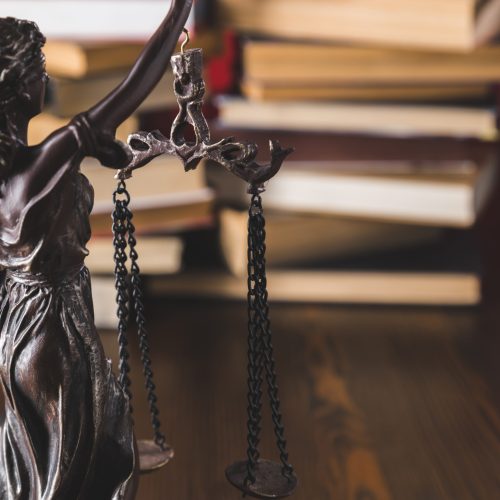 statue lady justice on wooden table with books, law concept